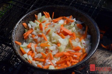 Теперь сделаем зажарку, делать ее лучше в то время, когда костер прогорает. Обжариваем до полуготовности на растительном масле нарезанные лук и морковь.