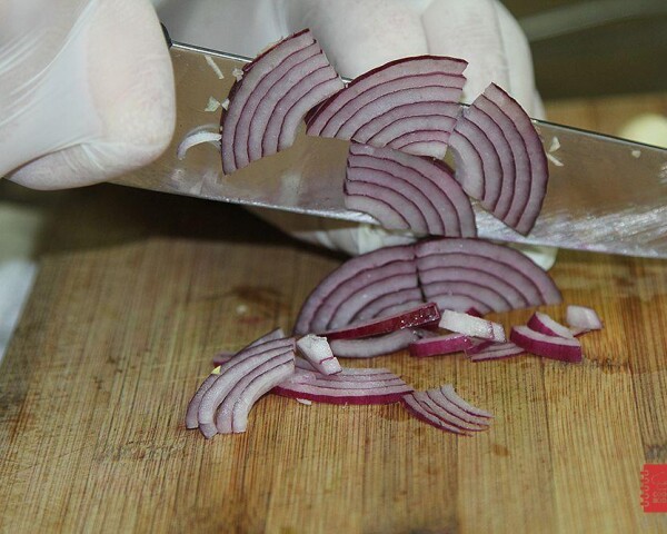 Четвертинами колец нарезаем красный лук